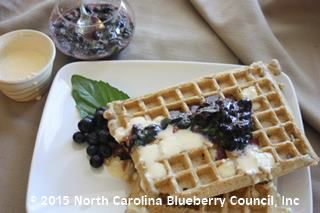 image Blueberry-Basil Compote over Blueberry Waffles with Orange Cheesecake Drizzle